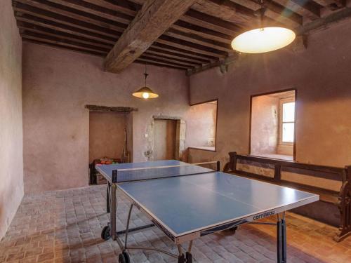 a ping pong table in the middle of a room at Mansion in Burgundy near Morvan Natural Park in Moussy
