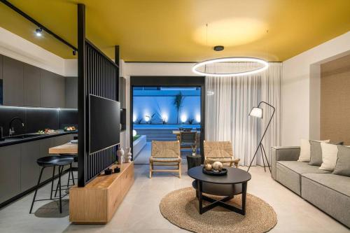 a living room with a couch and a table at Assos Aqua Apartment in Heraklio Town