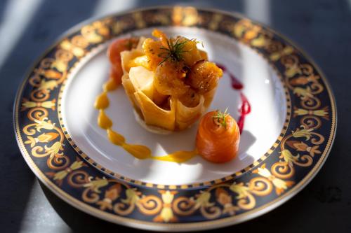 a plate with a waffle with shrimp and carrots on it at Oase by 7 Star Lodges - Greater Kruger Private 530ha Reserve in Hoedspruit