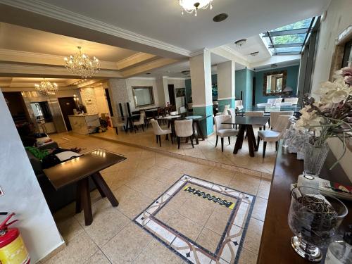 a living room with tables and chairs and a dining room at Apartments Villa Effie in Paralia Katerinis