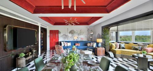 a living room with a couch and a tv at Taj Mahal, New Delhi in New Delhi