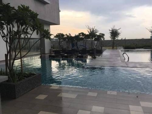 a swimming pool in front of a building at Aurora Residence @ PUCHONG PRIMA in Puchong