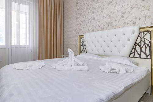 a white bed with white towels on it at Жк Millennium Park, Большие Апартаменты на площади страны in Astana
