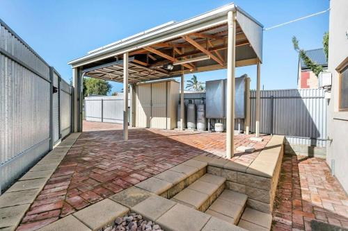 an outdoor patio with awning on a building at Captains Quarters Goolwa in Goolwa
