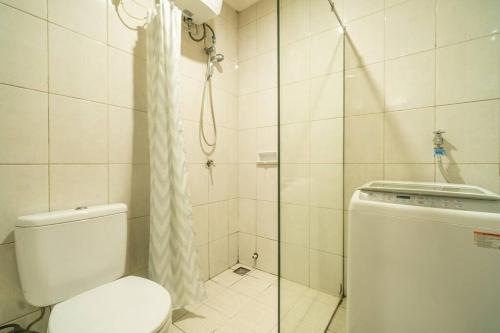 a bathroom with a toilet and a shower at Modern & comfy studio in central Jakarta, SCBD in Jakarta