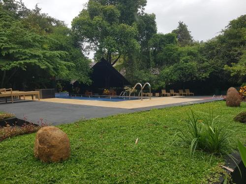 a park with a playground and a play area at Nice Place Resort in Dambulla