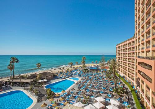 an aerial view of a resort with a swimming pool and the beach at Sunset Beach Club Hotel Apartments in Benalmádena