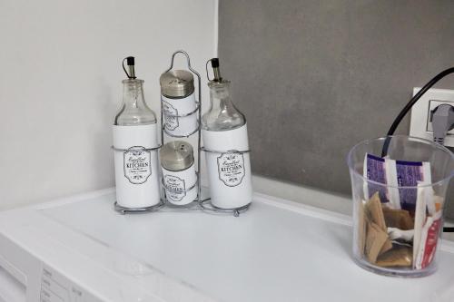 tre bottiglie sedute sopra un bancone di Margò Luxury a Mola di Bari