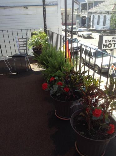 a group of potted plants sitting on a balcony at Empress Hotel in New Orleans