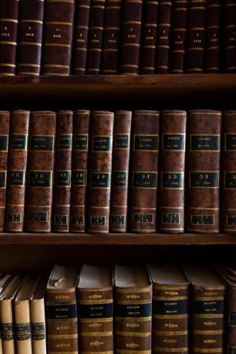 a row of books on shelves in a library at Château de Collias in Collias