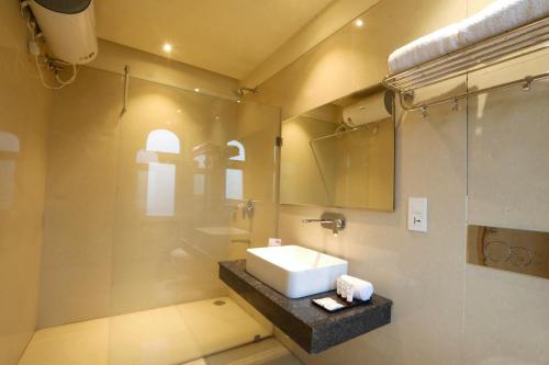 a bathroom with a sink and a glass shower at Perfect Plus just 5 mins walk to Golden Temple in Amritsar