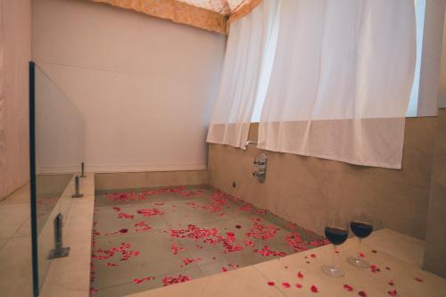 a room with a table with two wine glasses on it at Angirasa Luxury Camping in Hyderabad