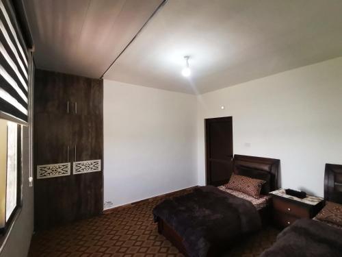 a bedroom with a bed and a couch in it at Top "OverView" Resort اطلالة القمة in Al ‘Āmirīyah
