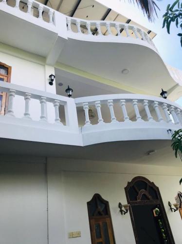 a balcony on the side of a house at Pearl Rest in Mannar
