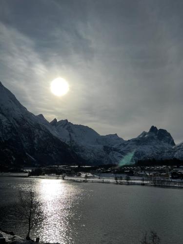 a view of a lake with snow covered mountains at Frichs Ekspress Åndalsnes in Åndalsnes