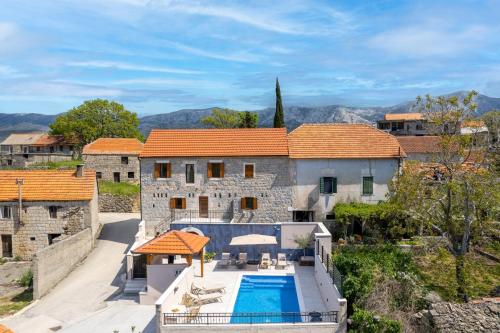 an aerial view of a house with a swimming pool at New! Charming Villa Perina with private heated pool in Tugare
