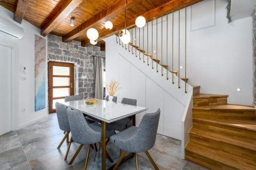 a dining room with a table and chairs at New! Charming Villa Perina with private heated pool in Tugare