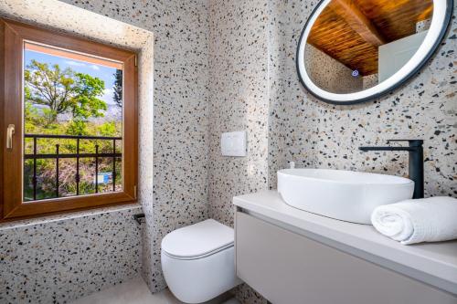 a bathroom with a sink and a mirror and a window at New! Charming Villa Perina with private heated pool in Tugare