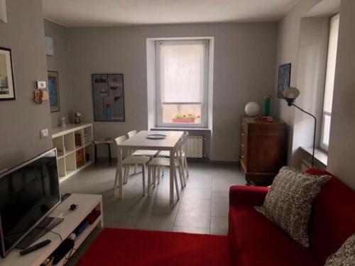 a living room with a couch and a table and a window at Giuditta FreeCarPark&Garden in Domodossola