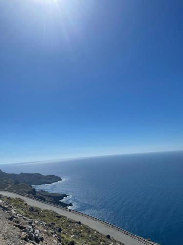 a view of the ocean from the top of a hill at Mediterranean Dolphin Guest House in Paránimfoi