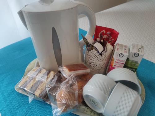 a table with a tea pot and other items on it at Hostería VISTAPARK in El Astillero