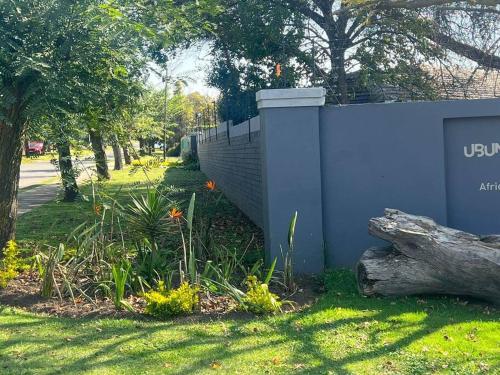 a fence with a log next to a yard at Ubuntu Lifestyle Estate - Nkandla DeLux in Krugersdorp
