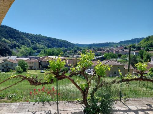 a view of a town from behind a fence at Appartement sur Vals les bains in Vals-les-Bains