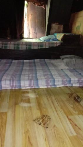 a mattress on a wooden floor in a room at Batad Family Inn and Hidden Hut in Banaue