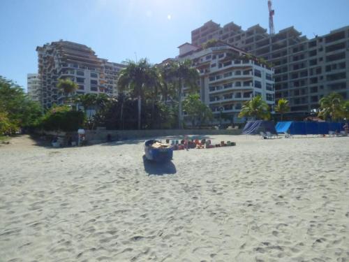 a person sitting in a chair on a beach at Bello Horizonte * Unido Al Mar in Santa Marta