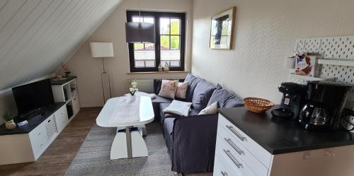 a living room with a couch and a table at Ferienwohnung "Seeblick" in Zingst