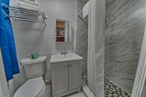 a bathroom with a white toilet and a sink at Aqua View Motel in Panama City Beach