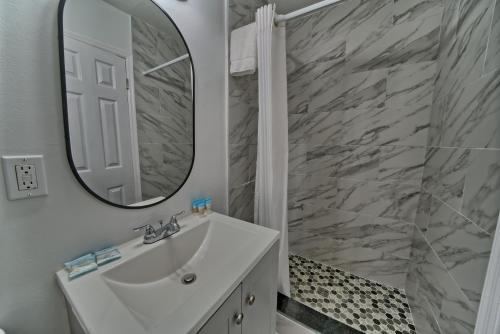 a bathroom with a white sink and a mirror at Aqua View Motel in Panama City Beach
