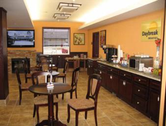 a restaurant with a table and chairs and a kitchen at Days Inn by Wyndham Athabasca in Athabasca