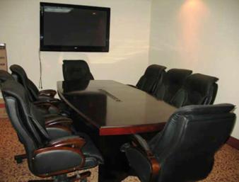 a conference room with a table and chairs and a flat screen tv at Days Inn by Wyndham Athabasca in Athabasca