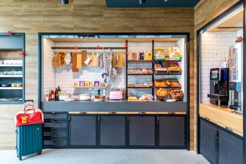 a bakery with its door open with food inside at Moxy Plymouth in Plymouth