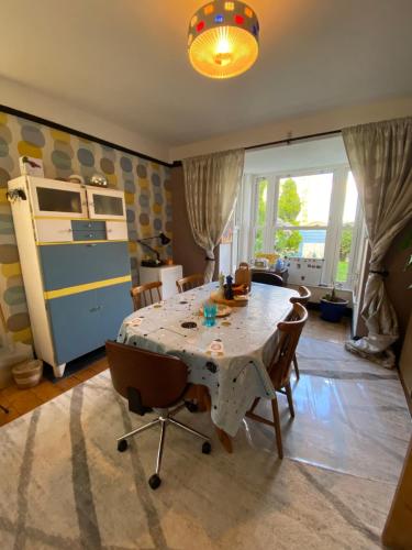 a kitchen with a table and chairs in a room at Homecroft in Saundersfoot