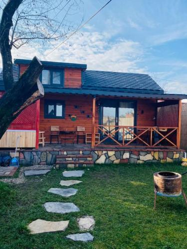a log cabin with a stone path in front of it at Maşukiye pink house bungalow in Kartepe