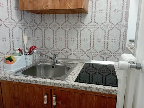 a kitchen counter with a sink in a room at Antico Monastero in Bitonto