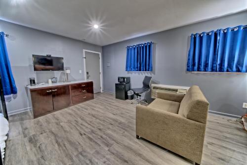 a living room with a couch and a desk at Aqua View Motel in Panama City Beach