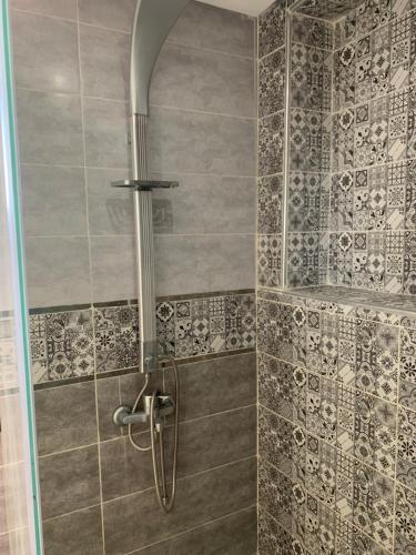 a shower with a glass door in a bathroom at El mar beach 2 in Moulay Bousselham