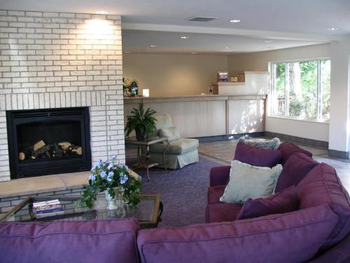 a living room with two purple couches and a fireplace at River Terrace Inn in Green River
