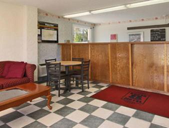 a room with a table and chairs and a couch at Americas Best Value Inn Tucker in Tucker