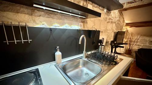 a kitchen sink with a faucet on a counter at Villa Casaviva in Komiža