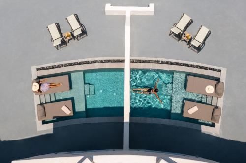 an overhead view of a person swimming in a pool at Lavadoze Luxury Suites in Éxo Goniá