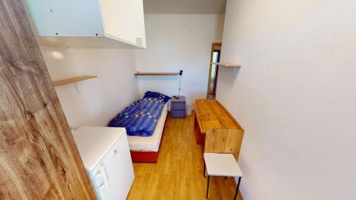 a small room with a bed and a table at U MIRASE Heřmaničky in Heřmaničky