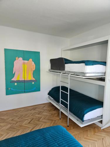 a bedroom with two bunk beds in a room at The Green Door Apartment in Postojna