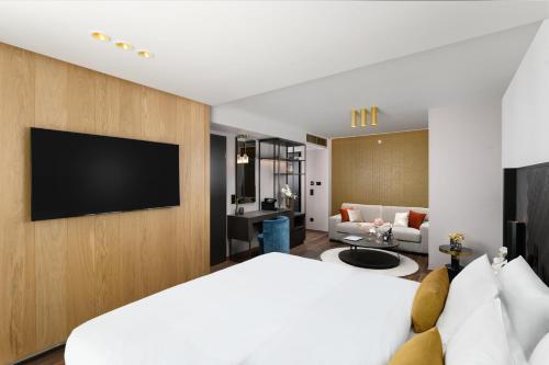 a hotel room with a bed and a tv at Hotel Vinifera Wine & Spa 5 Stars Superior in Balatonfüred