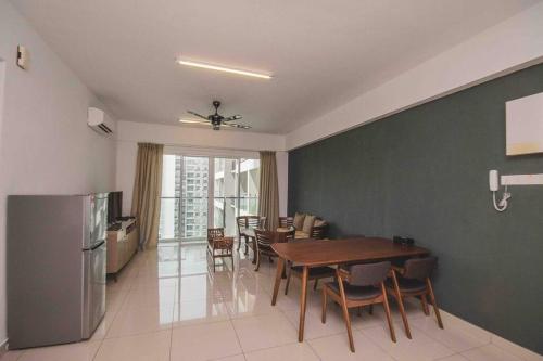 a kitchen and dining room with a table and a refrigerator at 3 bedroom condo with Pool near Queensbay Mall in Bayan Lepas