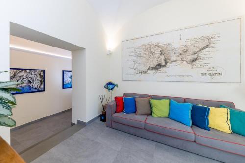 a living room with a couch with colorful pillows at Casa Dani Capri in Capri