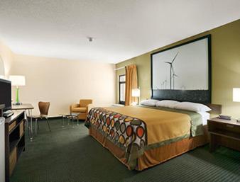 a hotel room with a bed and a television at Super 8 by Wyndham Columbia City in Columbia City